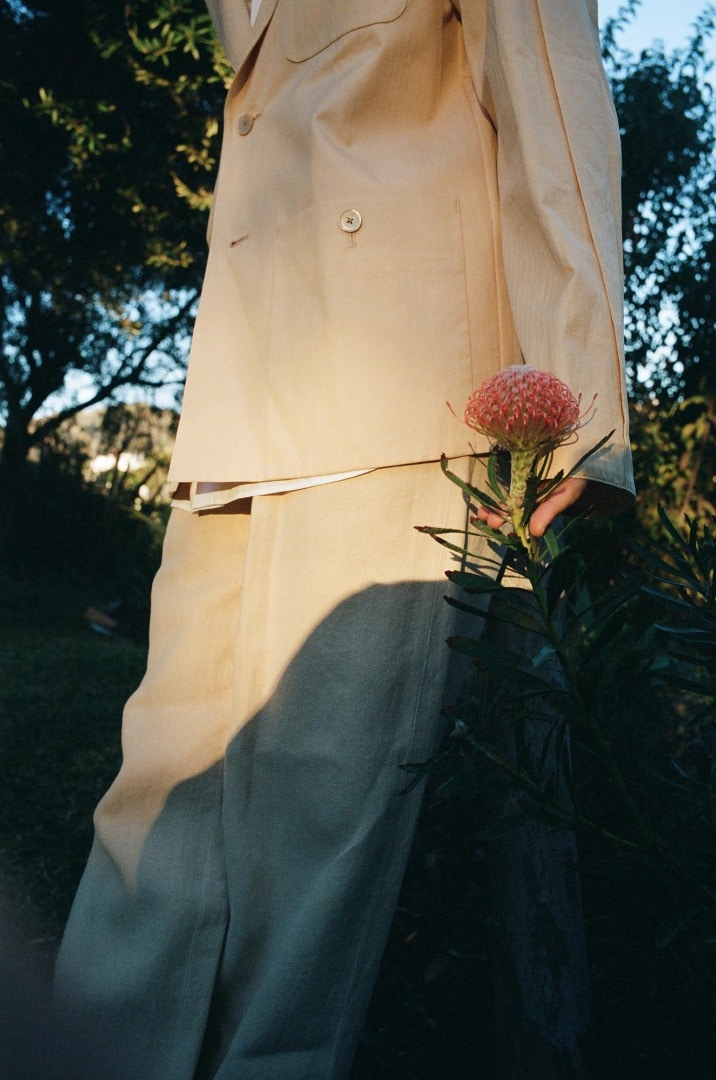 Clara wears Washed Finx Herringbone Jacket in Yellow Chambray, Washed Finx Twill Shirt in White, Washi Duck Canvas Slacks in Yellow Chambray