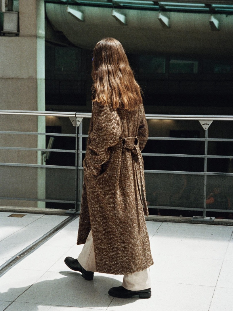 Marie wears Wool Alpaca Herringbone Tweed Double Coat in Brown Herringbone, Botanical Dyed Selvedge Denim Pants in Natural Pink and Leather Square Boots Made by Foot the Coacher in Black