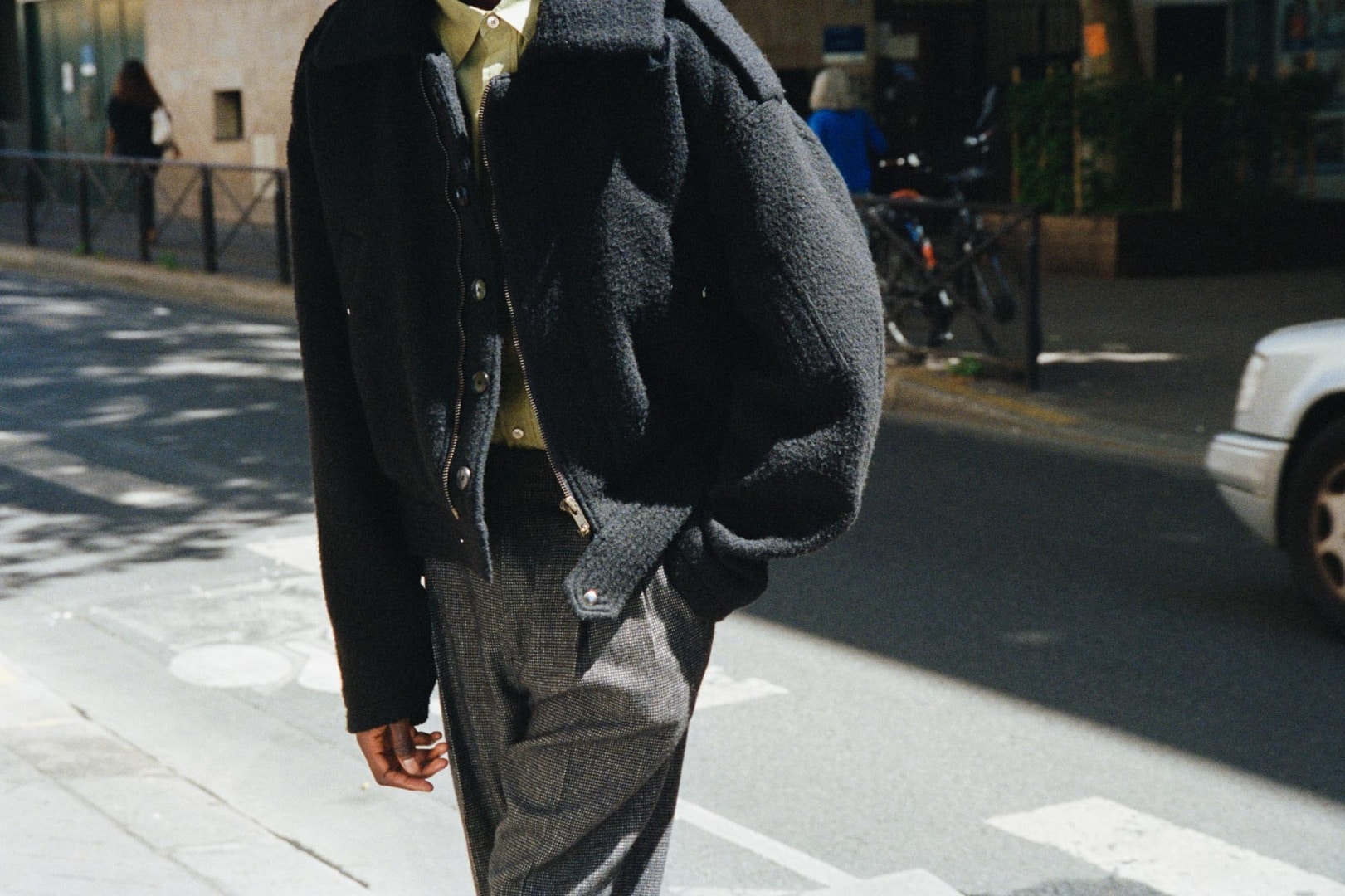 Baba wears Brushed Baby Camel Melton blouson in Black, Organic Cotton Cashmere Wool Tweed Two-tuck Slacks in Top Charcoal and Finx Ox Chambray Shirts in Yellow Beige Chambray.