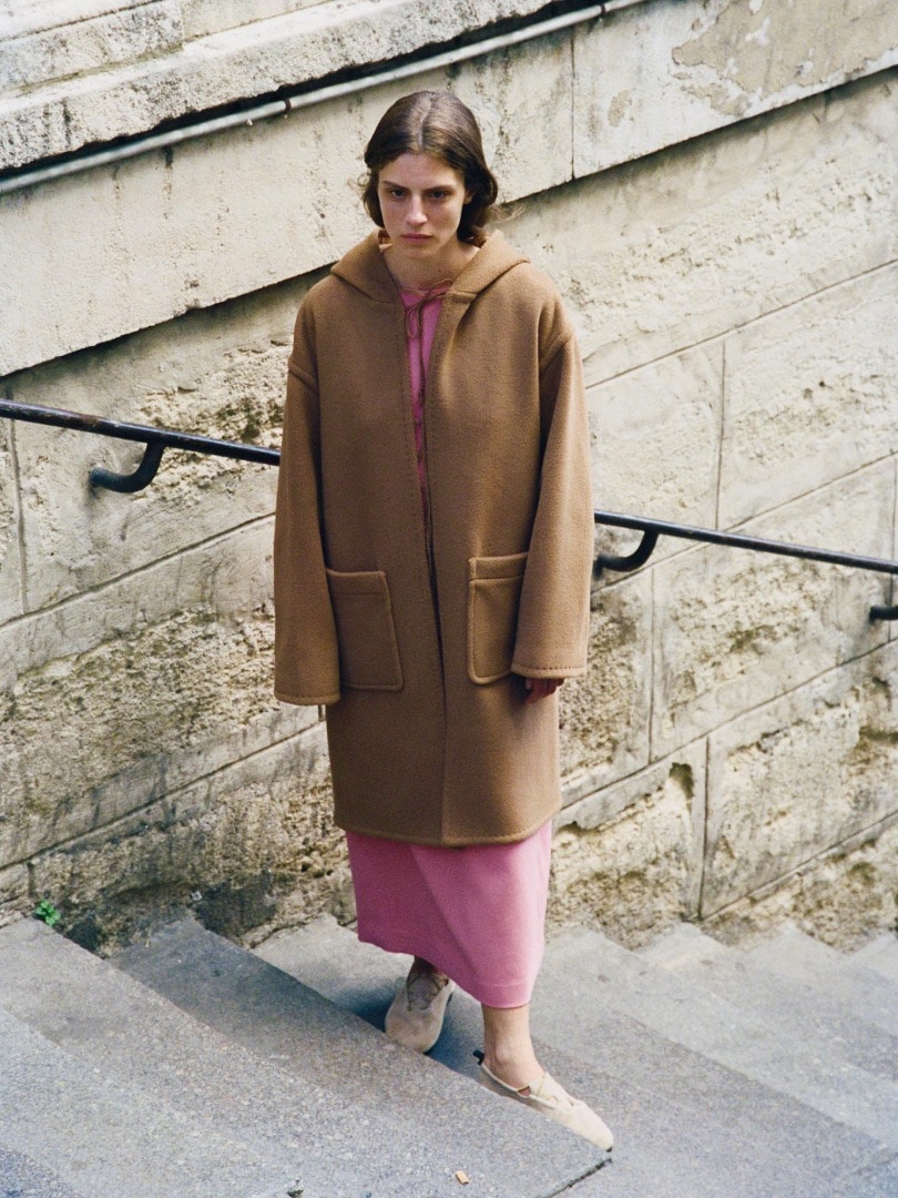 Marie wears Wool Herringbone Pile Hooded Coat in Brown, Tense Wool Double Cloth Dress in Pink and Lamb Suede Cord Shoes Made by Foot the Coacher in Dark Brown