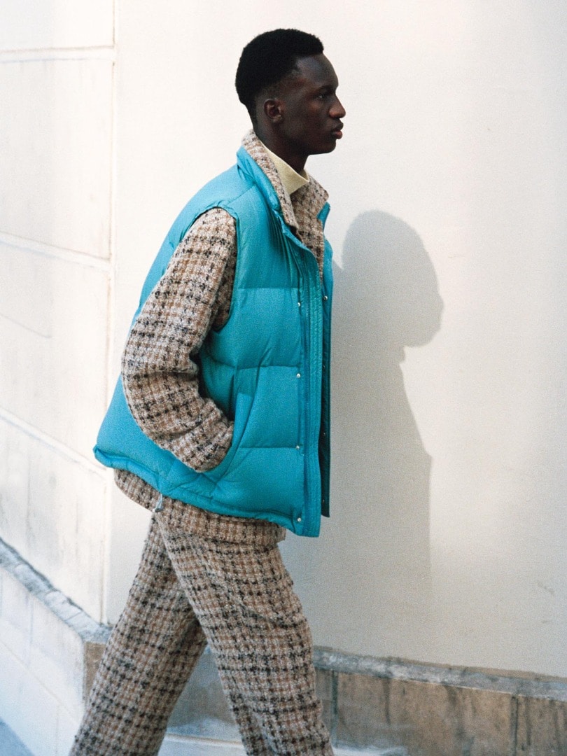 Baba wears Suvin High Count Cloth Down Vest in Cerulean Blue, Homespun Tweed Shirts Blouson, Homespun Tweed Slacks in Beige Tweed and Luster Plaiting Hi Neck L/S Tee in Beige.