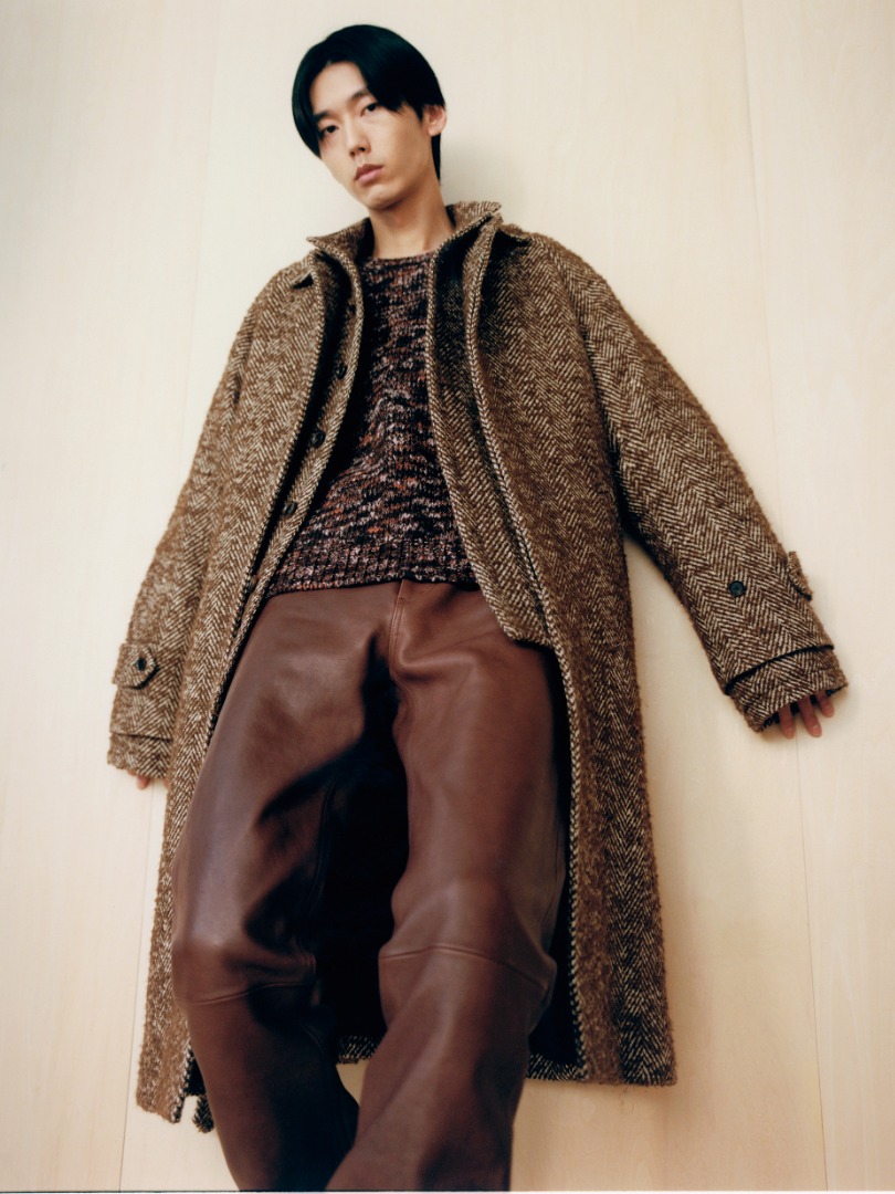 Dan wears Wool Alpaca Herringbone Tweed Soutien Collar Coat in Brown Herringbone, Wool Mix Color Slub Yarn Knit P/O in Mix Brown, Heavy Lamb Leather Pants in Brown