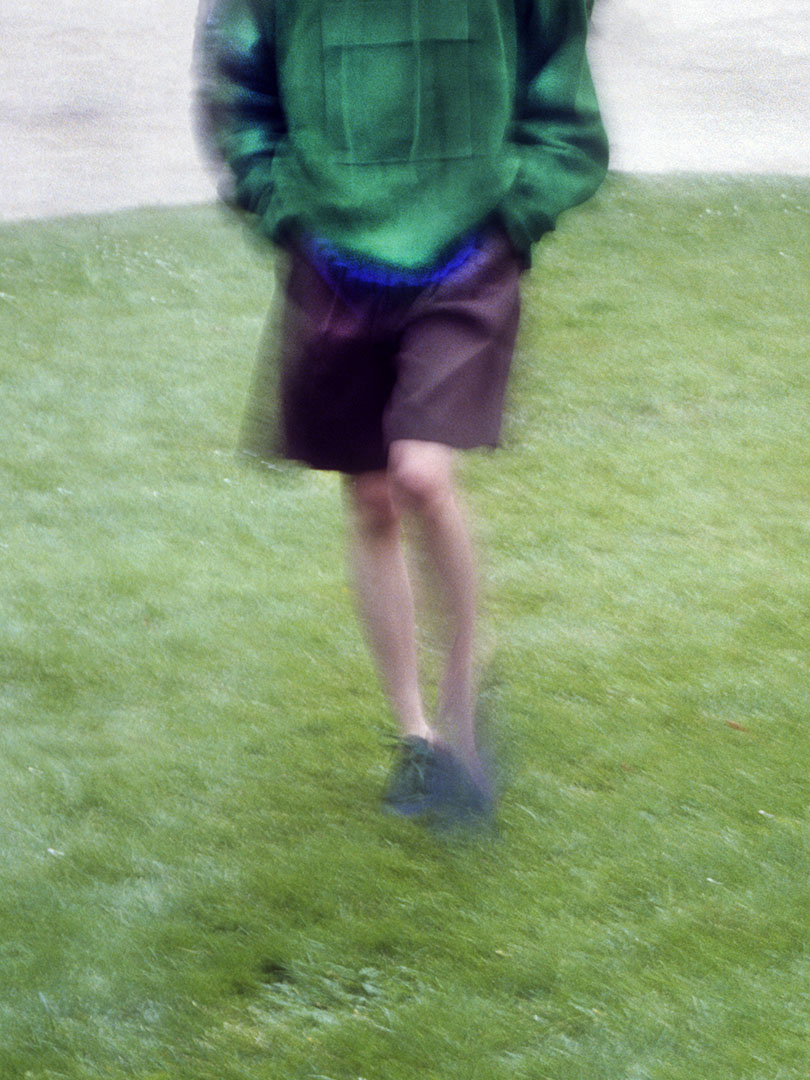Sechan wears Goat Suede P/O Blouson in Green, Light Wool Max Gabardine Shorts in Dark Brown