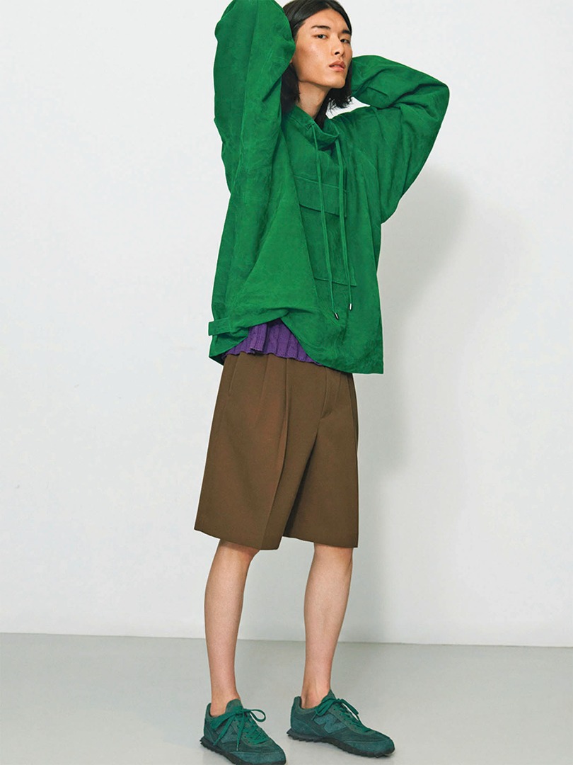 Sechan wears Goat Suede P/O Blouson in Geen, Light Wool Max Gabardine Shorts in Dark Brown