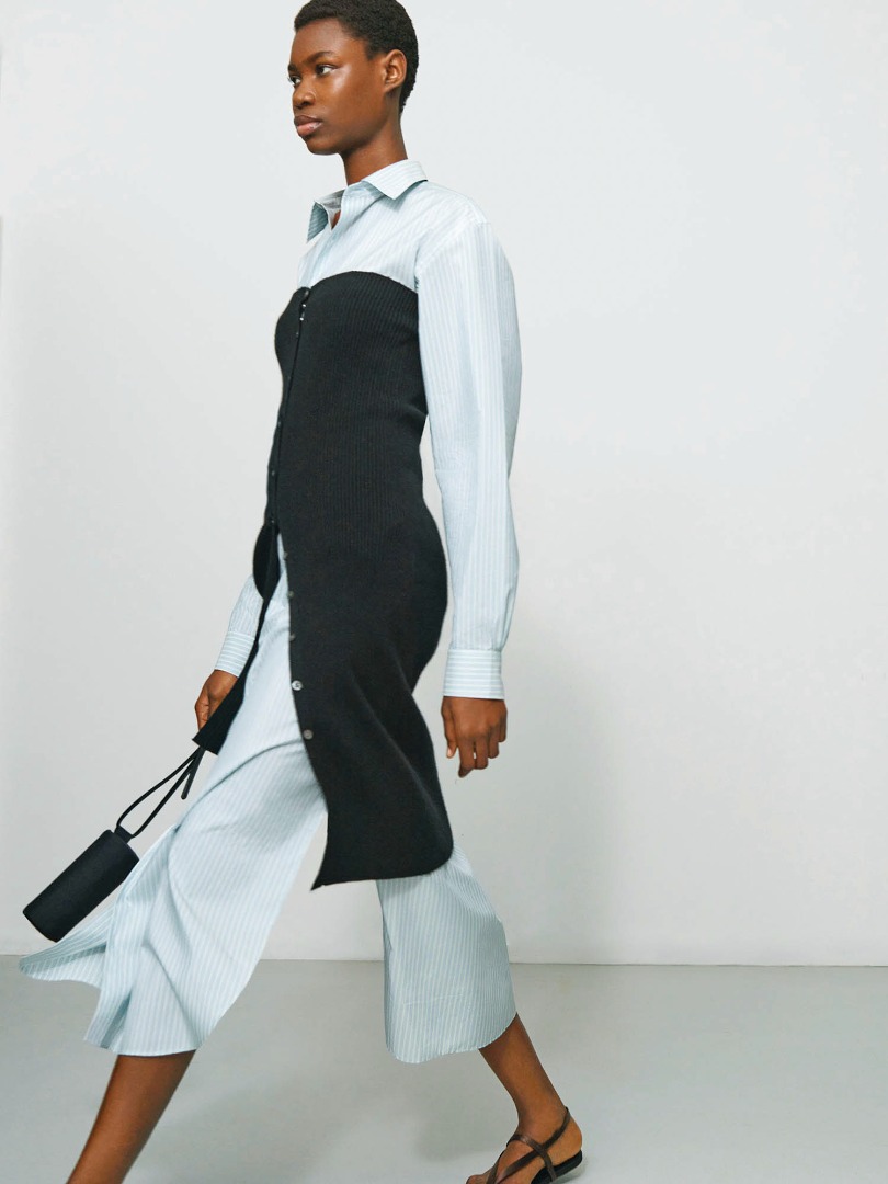 Elvina wears Finx Polyester Stripe Shirt One-Piece in Light Blue Stripe, Super Fine Cashmere Silk Knit Long Camisole in Black